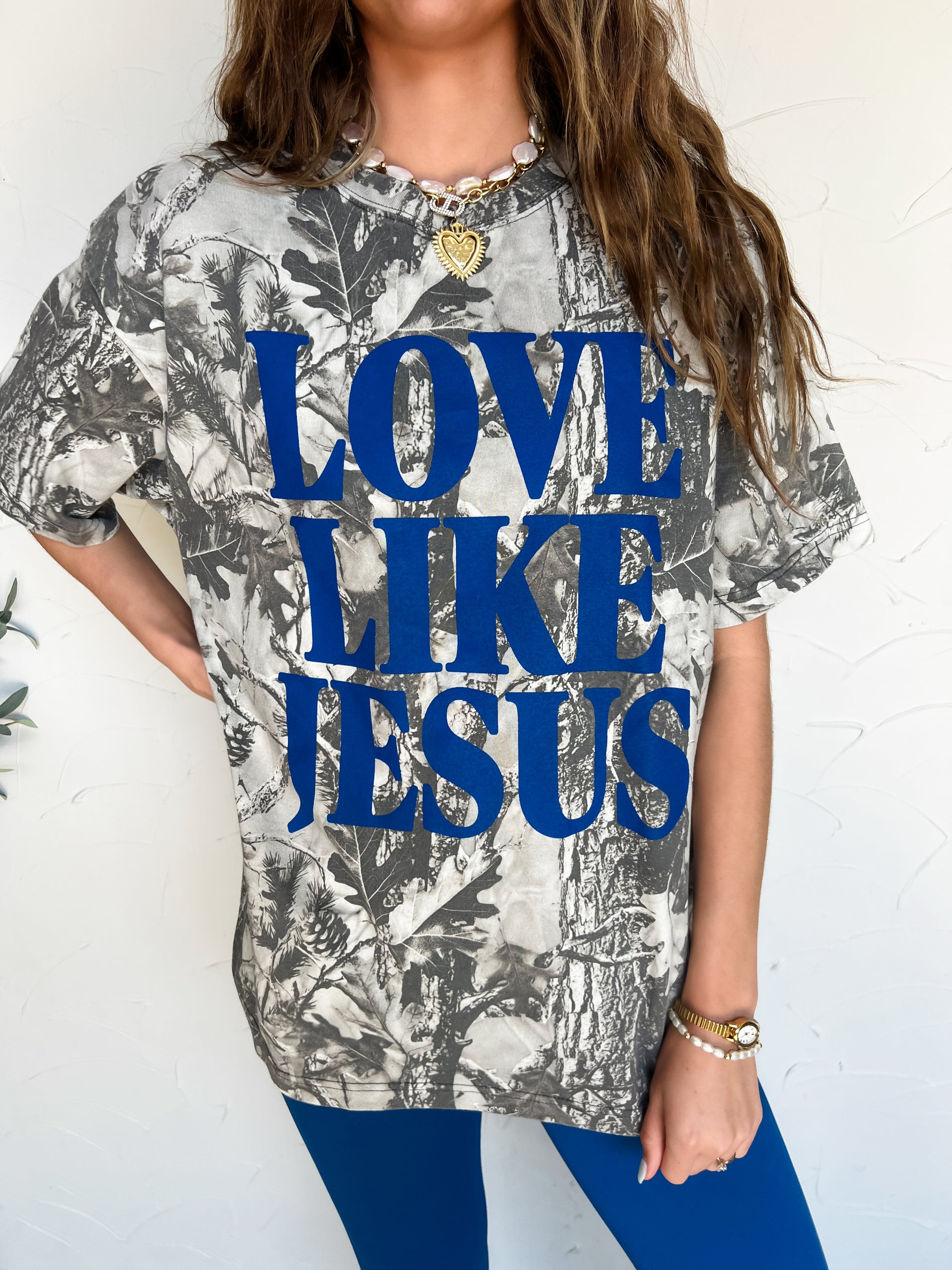 camo graphic with blue "love like jesus" text on the front 