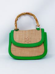 Handbag with green trim and bamboo handle on a white background