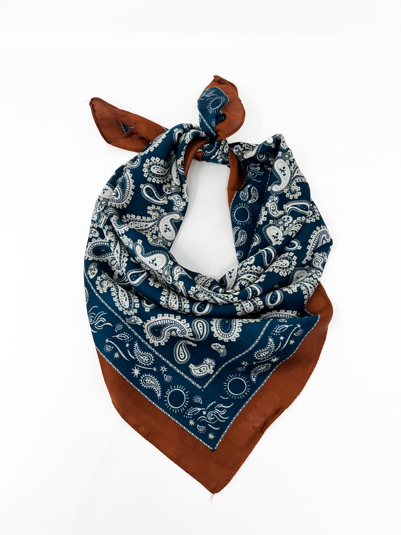 Blue bandana with white paisley patterns and brown edges on a white background