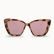 Cat-eye sunglasses with tortoiseshell frame and pink lenses on a white background