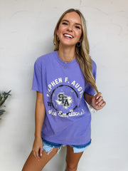 Woman wearing a purple Stephen F. Austin t-shirt against a white background