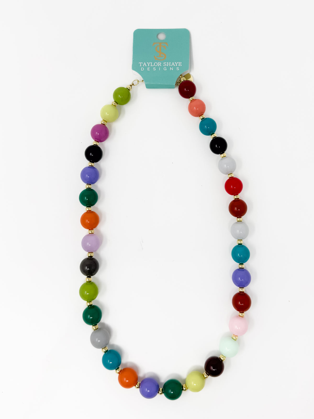 A multicolor beaded necklace with gold spacer rings, displayed on a white background with a teal brand card that reads Taylor Shaye Designs.