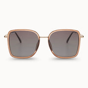 Sunglasses with rose gold frame and dark lenses on a white background