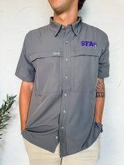 Person wearing a gray short-sleeve button-up shirt with a logo on a white background