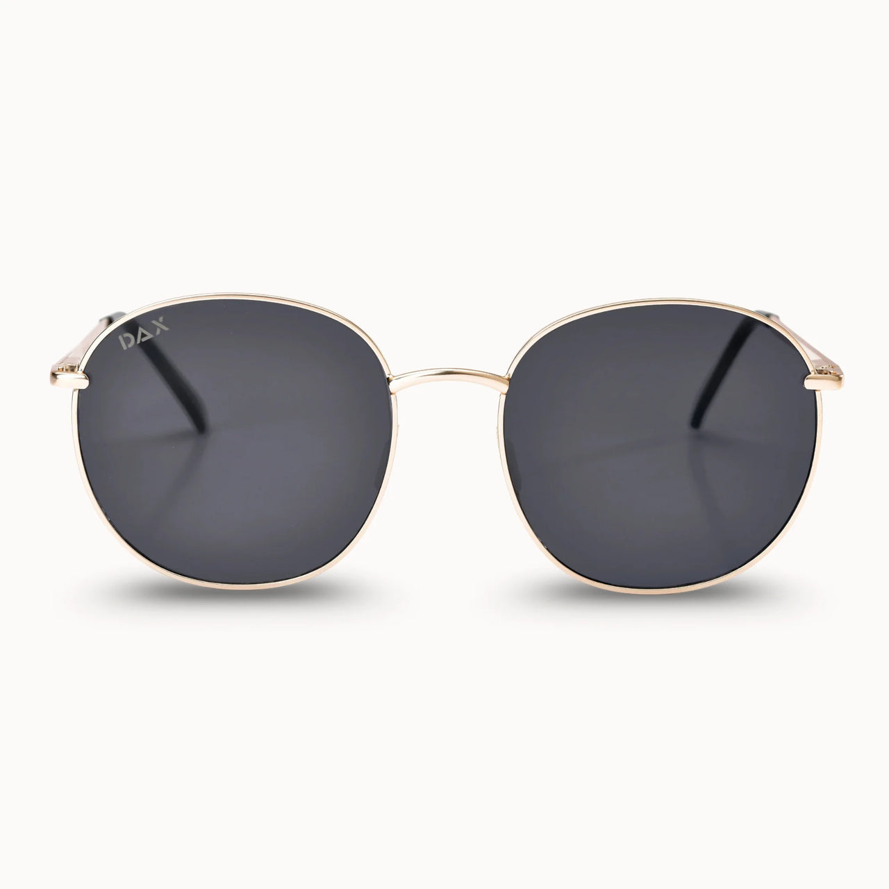 Gold-framed sunglasses with dark lenses on a white background