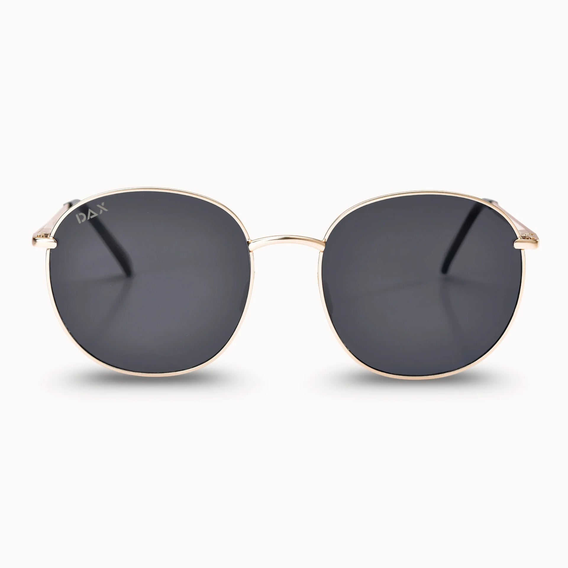 Gold-framed sunglasses with dark lenses on a white background