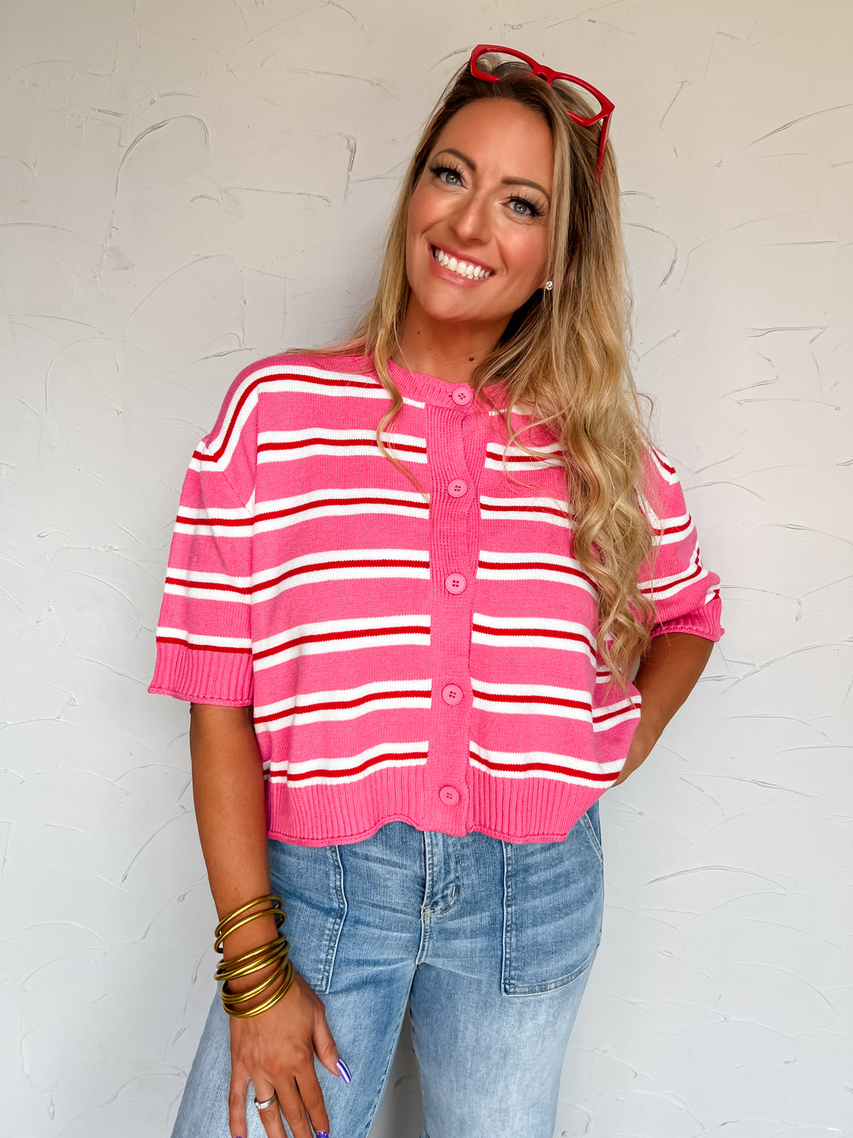Brand: LovLov
Color: Pink/Red, with white stripe accents
Horizontal striped design
Button-front cardigan
Short sleeves
Round neckline
Ribbed neckline, cuffs, and hem
Fabric content: 50% viscose, 28% nylon, 22% polyester