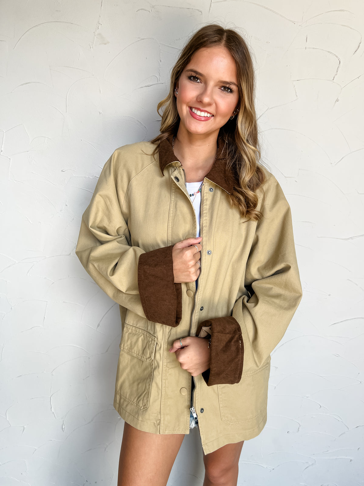 Grand Scheme Of Things Corduroy Work Jacket by Blu Pepper in 100% cotton, featuring a khaki body, brown corduroy collar and cuffs, front patch pockets, and a snap-covered zipper.
