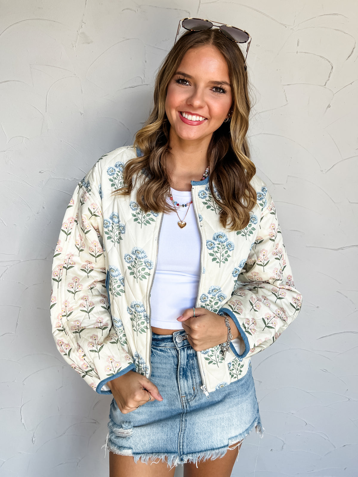 Potential In The Room Quilted Jacket by Eesome in 100% rayon, featuring a cream background, blue floral body, pink floral sleeves, blue trim, and zip front.