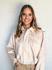 THML Joy In Every Thread Bubble Hem Jacket in pale beige, made of 97% polyester and 3% spandex, with a pointed collar, covered front placket, wide sleeves, and gathered bubble hem.