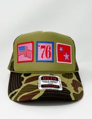 Green and camouflage trucker hat with patches on a white background