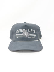 A gray snapback cap featuring white embroidered text that reads 'STEPHEN F. AUSTIN' and 'STATE UNIVERSITY' with a central crest, shown against a plain white background.
