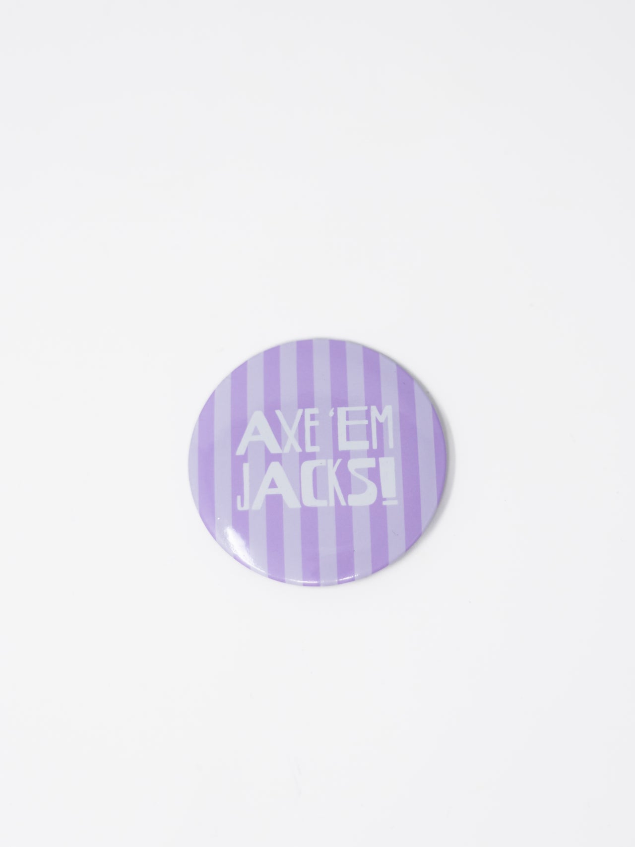 A round pin badge featuring a light purple and lavender-white vertical striped pattern with the text 'AXE 'EM JACKS!' in white, shown on a plain white background.