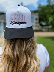 Person wearing a white and black cap with 'SEASU Lumberjacks' text, outdoors.