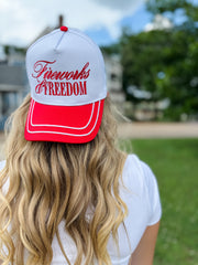 Person wearing a 'Fireworks for Freedom' cap outdoors