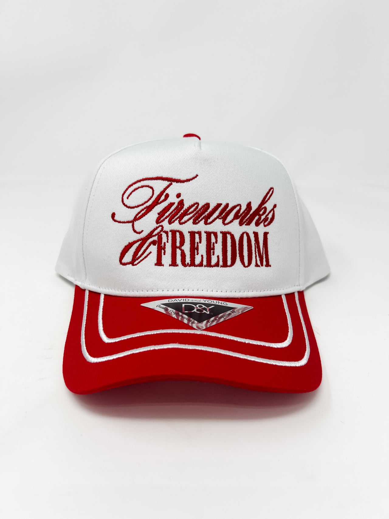 White and red cap with 'Fireworks & Freedom' text on a white background