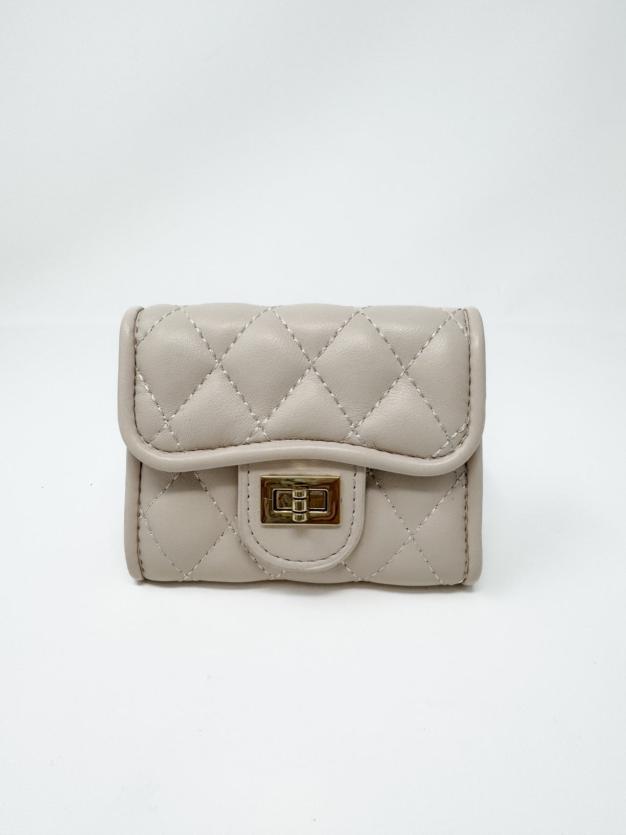 A small, compact taupe faux-leather wallet displayed against a solid white background. The wallet features a matte diamond-quilted pattern, a curved front flap, and a polished gold-toned metal turn-lock closure.