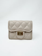 A small, compact taupe faux-leather wallet displayed against a solid white background. The wallet features a matte diamond-quilted pattern, a curved front flap, and a polished gold-toned metal turn-lock closure.