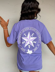 Person wearing a purple t-shirt with a star and text design on the back, against a plain background.