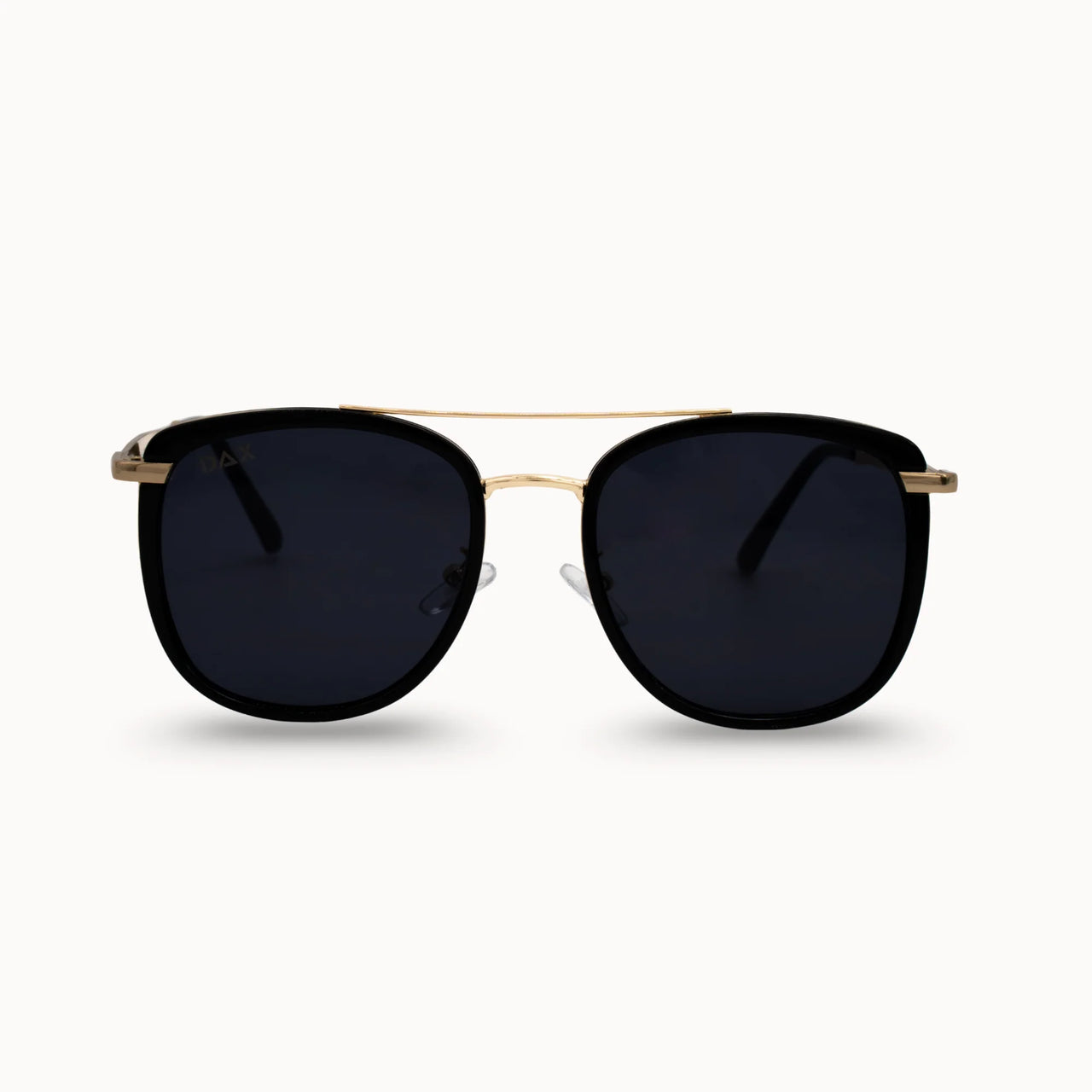 Sunglasses with black lenses and gold frame on a white background