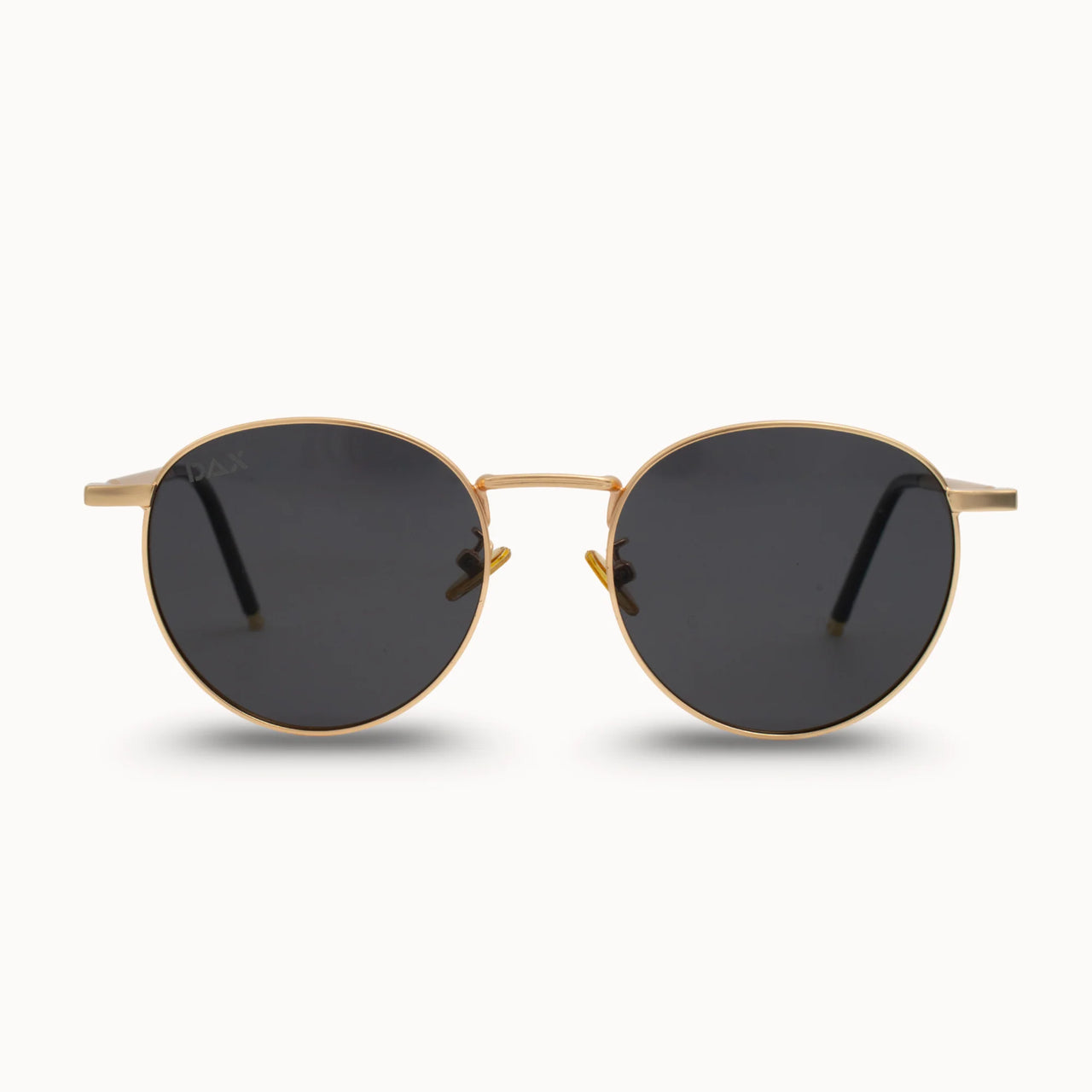 Gold-framed sunglasses with black lenses on a white background