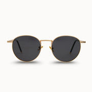 Gold-framed sunglasses with black lenses on a white background