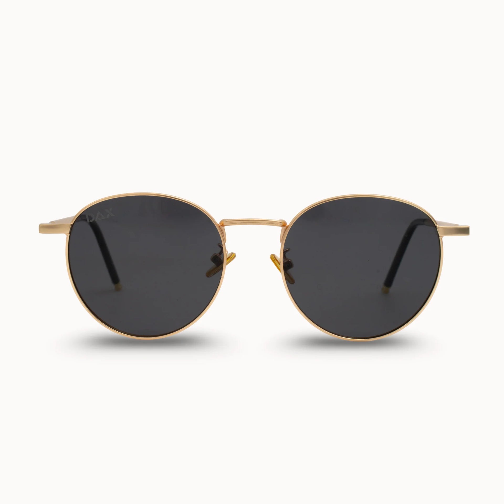 Gold-framed sunglasses with black lenses on a white background