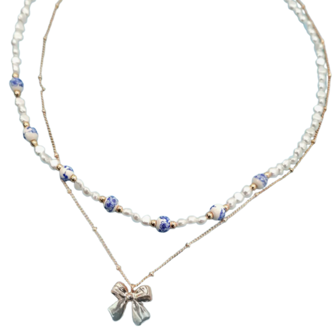 Two layered necklaces with a bow pendant with blue accents on a white background