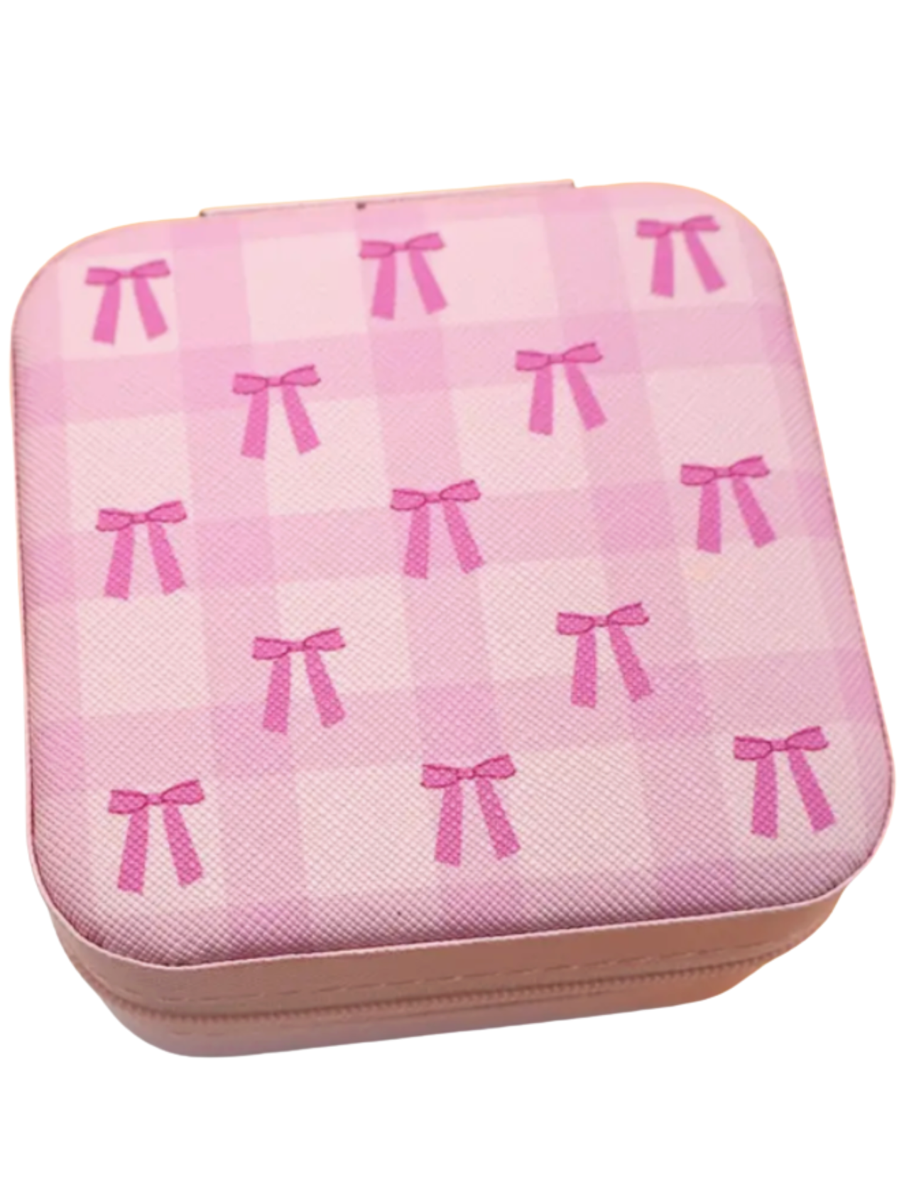 Pink square-shaped jewelry case with bow pattern on a white background
