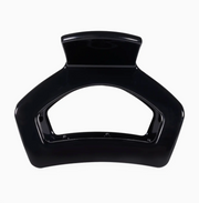A glossy black hair claw clip shown from a top-down view against a plain white background.