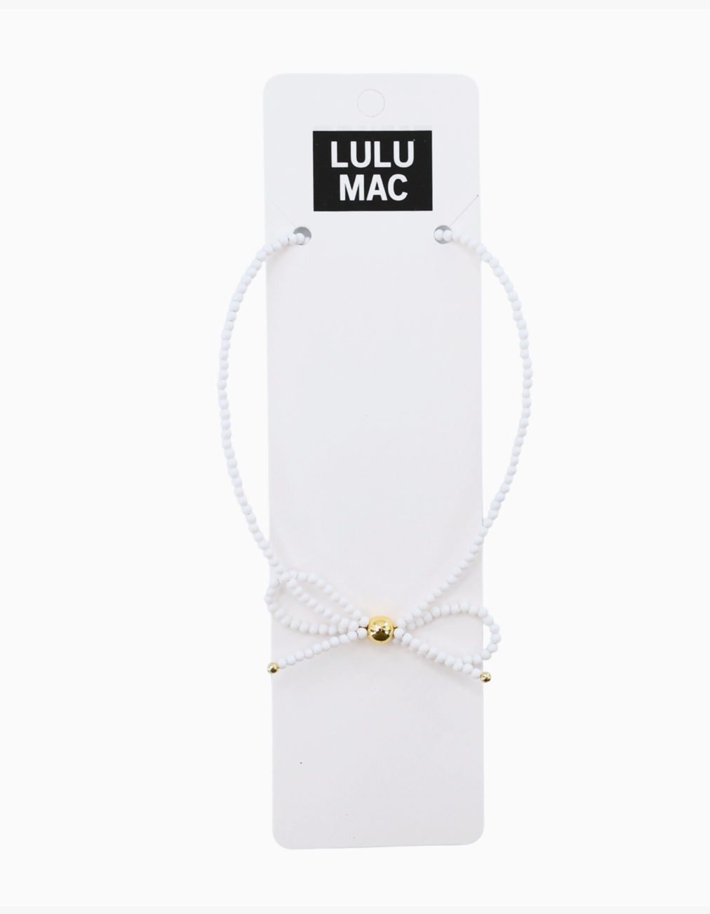 A white beaded bracelet with a small gold bead accent, displayed on a white card labeled 'LULU MAC' against a white background.