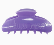 A purple plastic claw hair clip with the brand name 'LULU MAC' embossed on the front, shown against a plain white background.