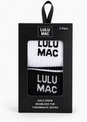 Lulu Mac half-crew seamless toe throwback socks in a black retail box. The socks are white and black with 'LULU MAC' text, shown through a clear window on the front of the packaging.