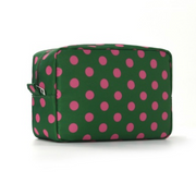A rectangular zippered cosmetic bag with a green and pink polka dot pattern, shown on a clean white background.