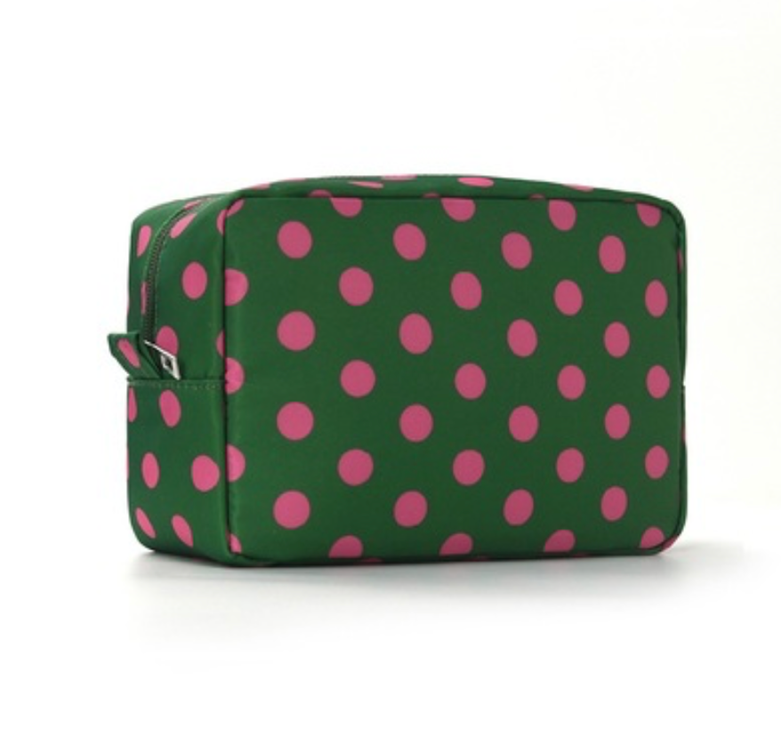 A rectangular zippered cosmetic bag with a green and pink polka dot pattern, shown on a clean white background.