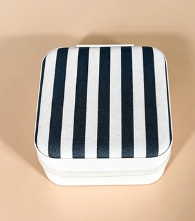 A square zippered case with a navy blue and white vertical stripe pattern, shown on a solid beige background.