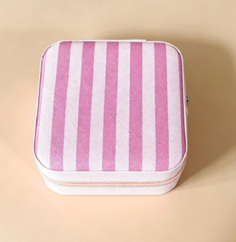 A square zippered pouch with vertical pink and white stripes, shown from a top-down view on a solid beige background.