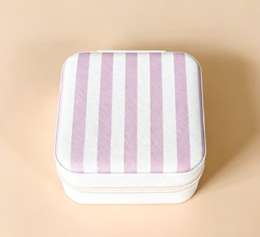 A square zippered storage case with a white and light pink striped pattern, shown on a solid beige background.