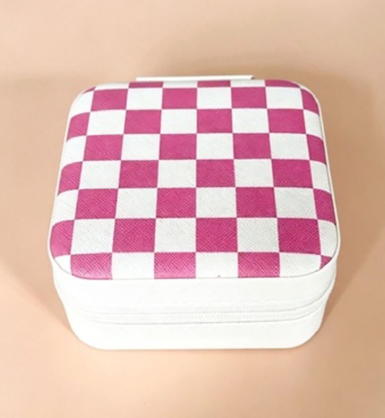A square zippered case with a pink and white checkerboard pattern on the lid, set against a solid beige background.