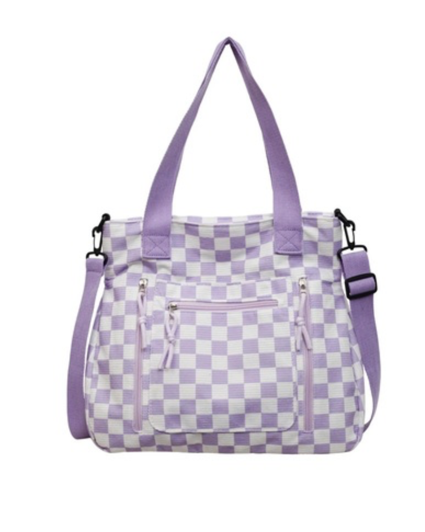 A lavender and white checkered tote bag with dual top handles, a detachable shoulder strap, and a front zippered pocket, shown against a plain white background.