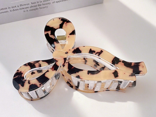 Tortoiseshell patterned hair clips on a white surface