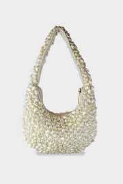 Pearl-handled handbag on a white background