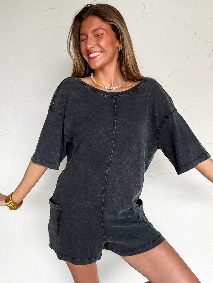 women wearing a black shorts sleeve/short romper with pockets