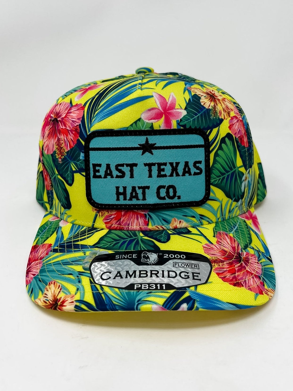 Colorful floral-patterned cap with 'East Texas Hat Co.' branding on a white background