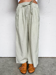 Striped wide-leg pants worn by a person on a white background