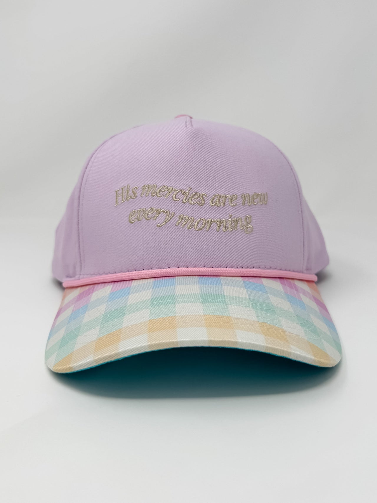 Purple cap with plaid brim and embroidered text on a white background