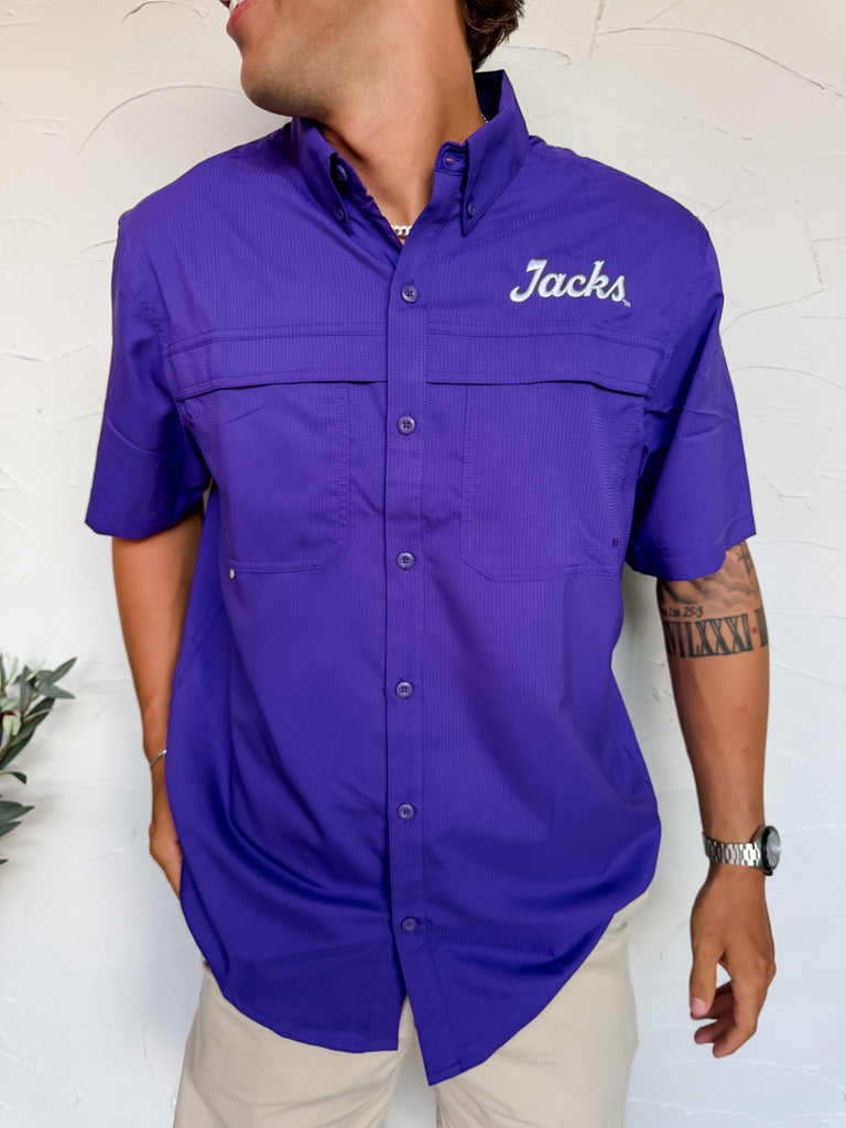 Person wearing a purple shirt with 'Jacks' branding against a white background