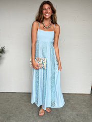 Woman wearing a light blue dress with a white background