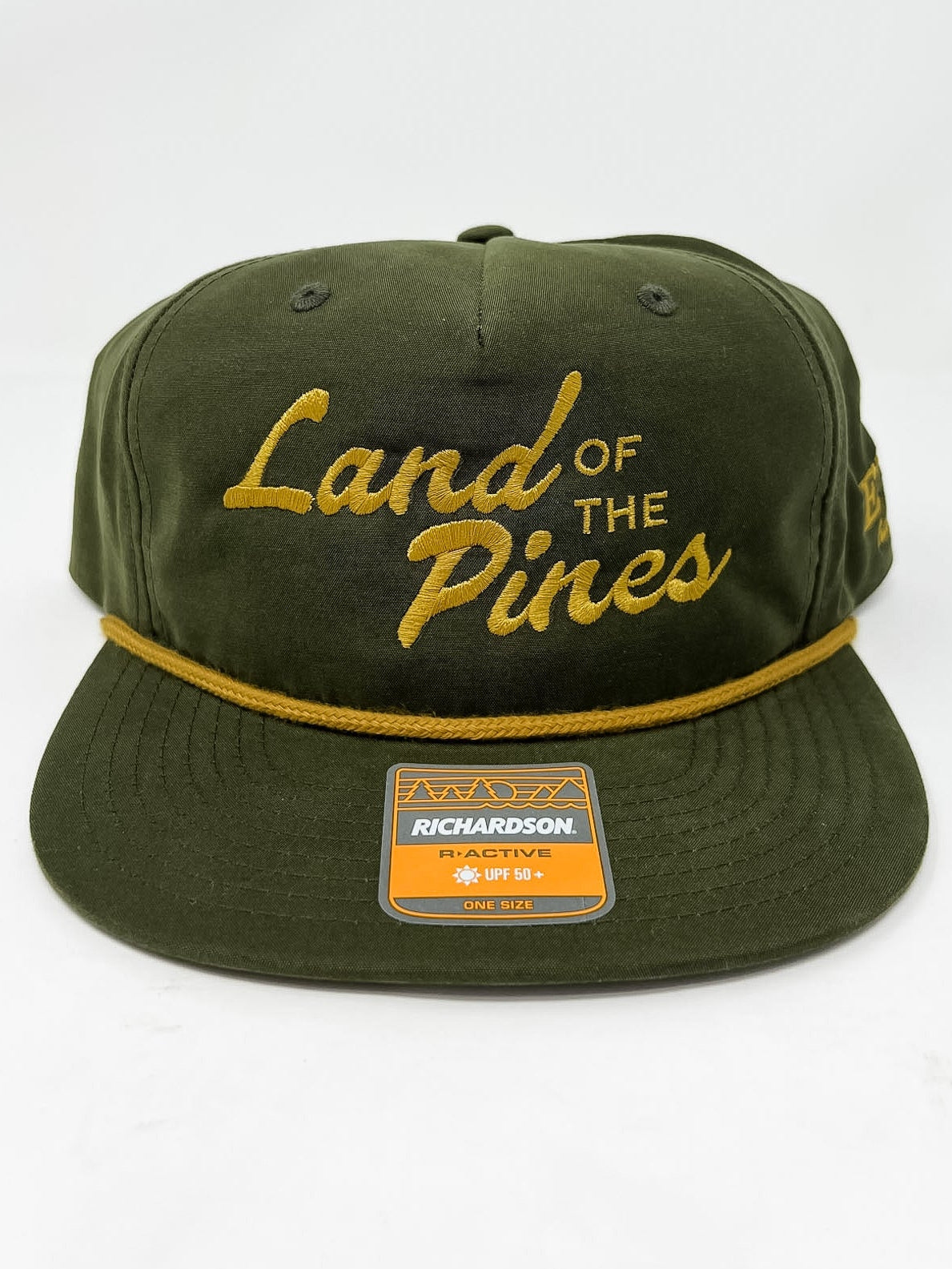 Green cap with 'Land of the Pines' text on a white background