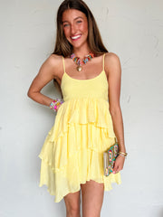 Woman wearing a yellow dress with a white background